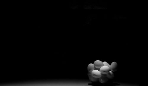 Close-up of cake on table against black background