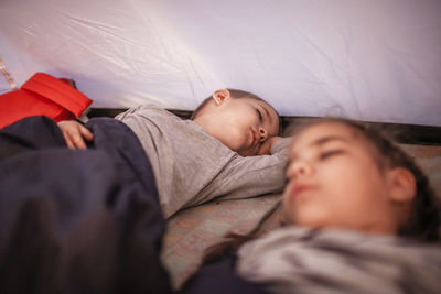 High angle view of people sleeping on bed