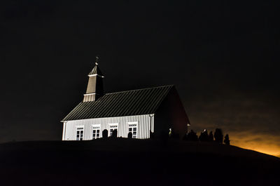 Silhouette of temple against sky at night