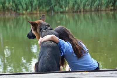 Woman with dog on lake