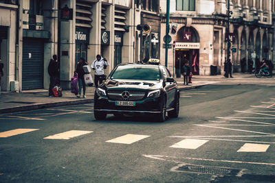 Vehicles on road along buildings