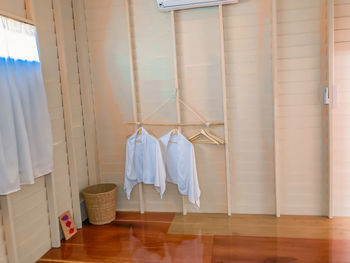 Clothes hanging on hardwood floor at home