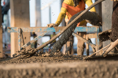 Close-up of worker working at construction site