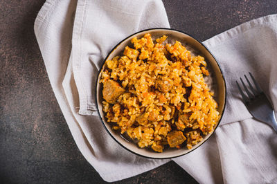 Close up of delicious asian pilaf with meat on a plate on the table top view