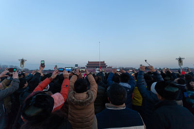 Rear view of people against clear sky