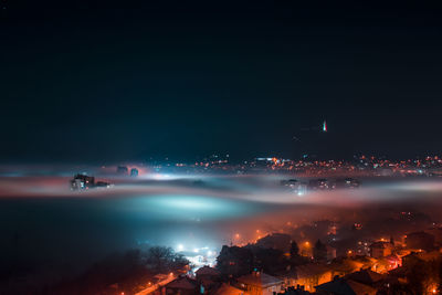 High angle view of illuminated buildings in city at night