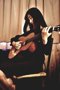 Young woman playing guitar