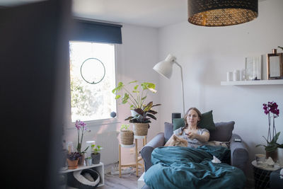 Woman watching tv in living room