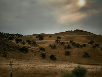 Scenic view of landscape against cloudy sky