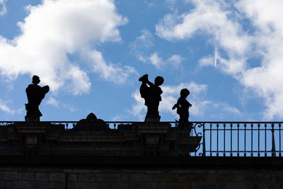 Low angle view of silhouette statue against sky