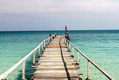 Pier over sea against sky