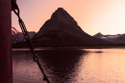 Scenic view of lake by mountains against clear sky