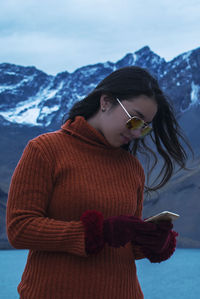 Woman standing on snow covered mountain