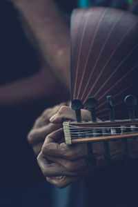 Close-up of man playing guitar