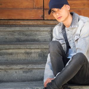 Portrait of teenage boy sitting on staircase