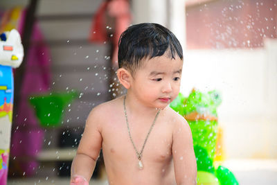 Full length of shirtless boy in water