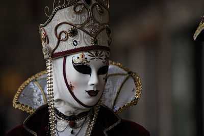 Close-up of person wearing mask and traditional clothing