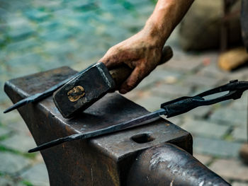 Close-up of man working on rusty metal