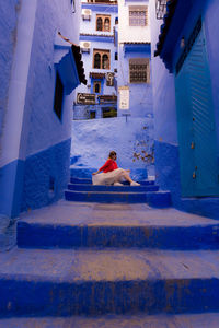 Man sitting by building