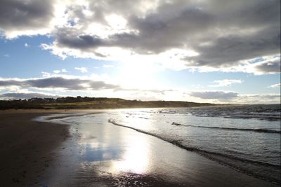 Scenic view of beach against sky during sunset