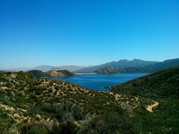 Scenic view of mountains against clear blue sky