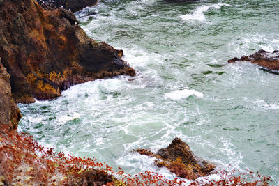 High angle view of rocks in sea