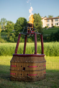 Hot air balloon on grass against sky