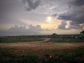 Scenic view of field against sky during sunset