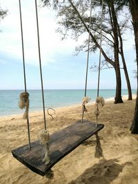 View of swing on beach against sky