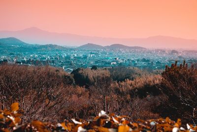 Panoramic view of land and mountains against sky during sunset