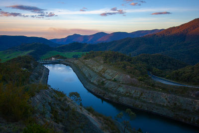 Scenic view of river amidst mountains against sky