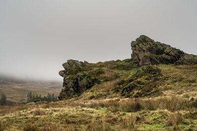 Rock formations on landscape against sky