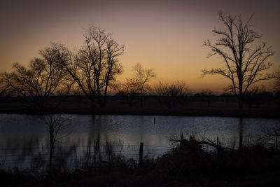 Scenic view of lake against sky at sunset