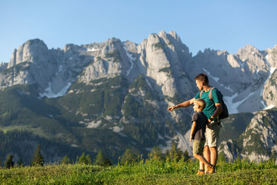 Rear view of man standing on mountain