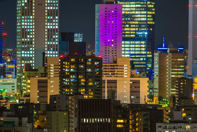 Illuminated buildings in city at night