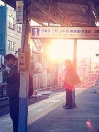 Silhouette of woman standing on footpath