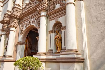 Low angle view of statue against historic building