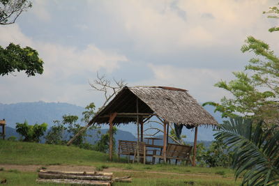 Built structure on field against sky