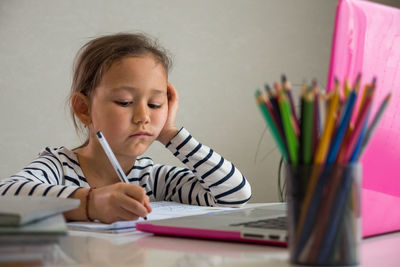 Portrait of boy sitting on table