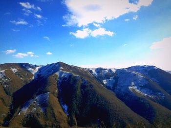 Scenic view of mountains against cloudy sky