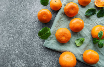 Fresh citrus fruits tangerines, oranges on a concrete background
