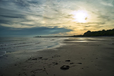 Scenic view of beach against sky during sunset