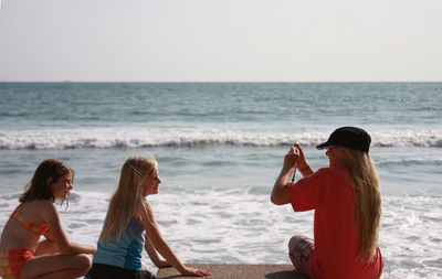 People on beach against sky