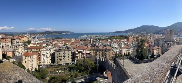 High angle view of buildings and sea against sky