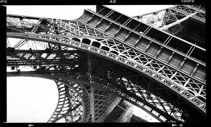 built structure, architecture, low angle view, transfer print, famous place, metal, travel destinations, building exterior, international landmark, architectural feature, auto post production filter, arch, capital cities, travel, eiffel tower, tourism, sky, tower, culture, clear sky