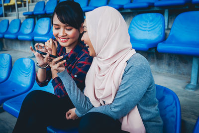 Full length of woman using mobile phone