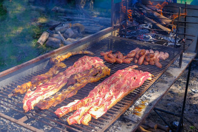 High angle view of meat on barbecue grill
