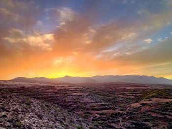 Scenic view of mountains against sky at sunset