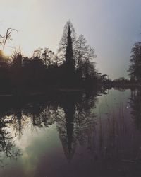 Reflection of trees in lake against sky
