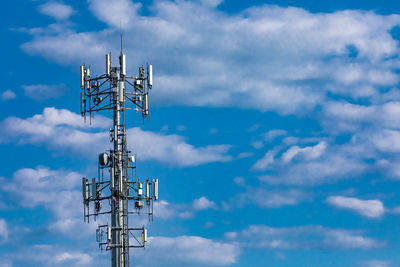 Low angle view of communications tower against sky